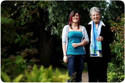 Young carer walking with her grandmother in the Botanic Gardens