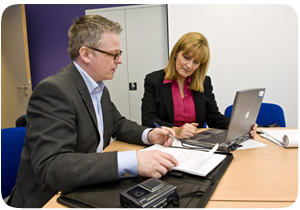 A lady discussing her will with a solicitor 